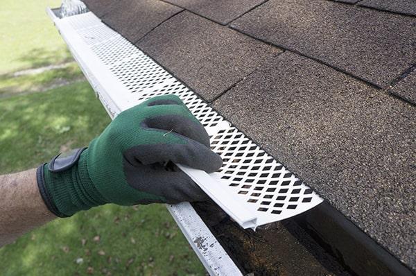 installing gutter guards involves attaching the guards securely to the top edge of the existing gutters to effectively block debris from entering